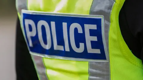 Getty Images Officer wearing police vest