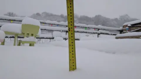 Lauren and Joshua Morris A tap measure in the snow
