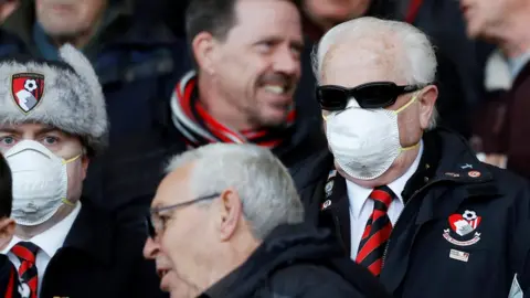 Reuters Bournemouth fans wearing face masks due to the recent coronavirus outbreak