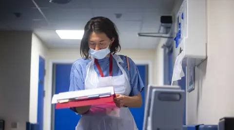 Getty Images Hospital staff looking a notes