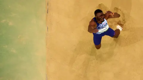 DEAN MOUHTAROPOLOUS/GETTY IMAGES Hugues Fabrice Zango of Burkina Faso competes in the triple jump final.