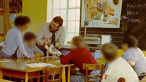 Other Ron Morris teaching boys in a classroom