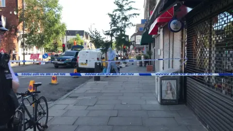 Forensics teams at the crime scene near Finsbury Park