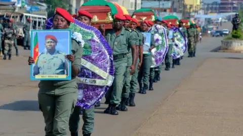 AFP Soldiers carry the coffins of the four soldiers killed in the violence that erupted in the Northwest and Southwest Regions of Cameroon, where most of the country's English-speaking minority live, during a ceremony in Bamenda
