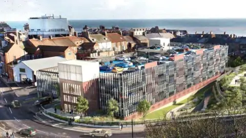 East Riding of Yorkshire Council Another artist's impression of the multi-storey car park in Bridlington. There are cars in the foreground, and terraced houses and the North Sea beyond the car park.