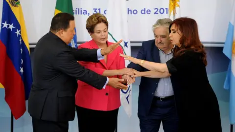 AFP Brazilian President Dilma Rousseff (2nd-L) holds hands with the presidents of Uruguay, Jose Mujica (2nd- R), Argentina, Cristina Kirchner (R), and Venezuela, Hugo Chavez ( L), before the Mercosur Extraordinary Summit, at Planalto Palace, in Brasilia, on July 31, 2012