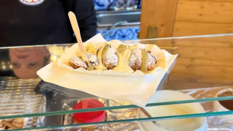 Kaya Black/BBC Mini pancakes topped with icing sugar, white chocolate and pistachio cream.