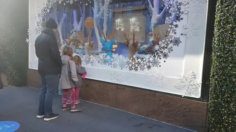 family looking in Macy's window