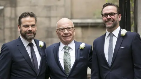 John Phillips Rupert Murdoch on his wedding day, with his sons Lachlan (L) and James (R)