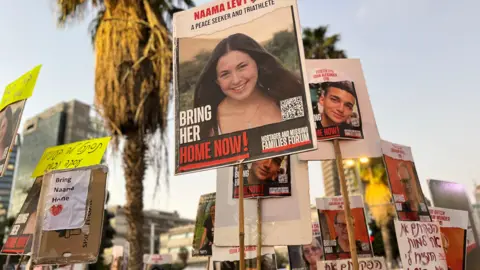 Naama appears on poster at protest in Tel Aviv