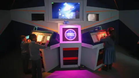 Getty Images Children play on Mission Control in the National Videogame Arcade