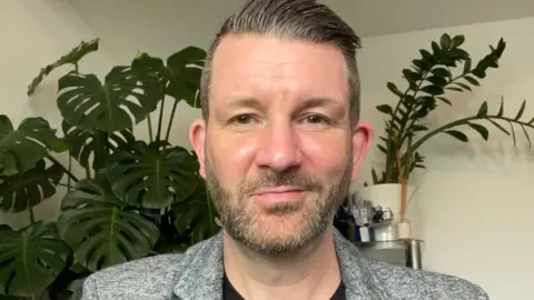 Martyn James Man in room.