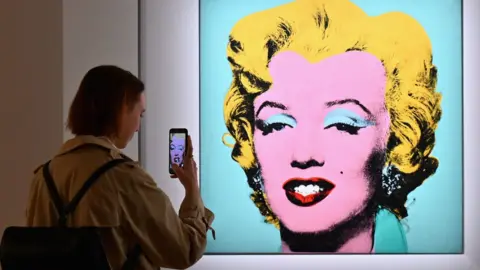 Getty Images Andy Warhol's "Shot Sage Blue Marilyn" at an auction preview in April