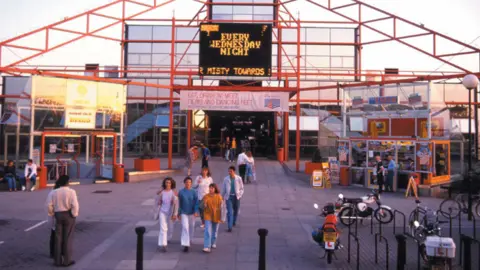 MK Living Archive An image of the outside of the multiplex cinema which had 10 screens. People are dressed in 80's fashion. 