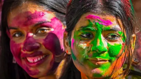 Students play with colours ahead of Holi festival, at KG Marg on March 12, 2025 in New Delhi, India