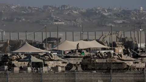 Reuters Israeli tanks and troops stationed near the Gaza perimeter, in southern Israel (3 September 2025)