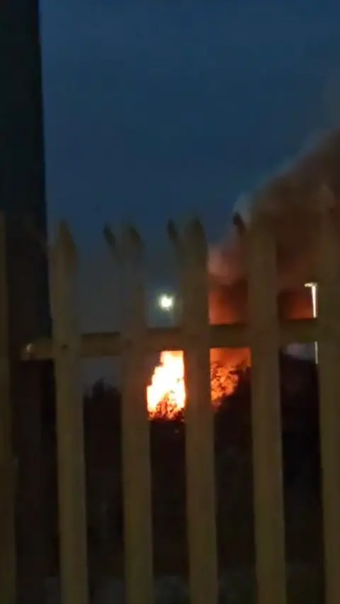 A large fire with smoke filling the sky.