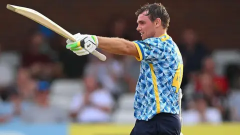 The Bears batsman Tom Latham celebrating his century against Derbyshire