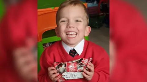 Emma Aldous‎ Douglas holds a present