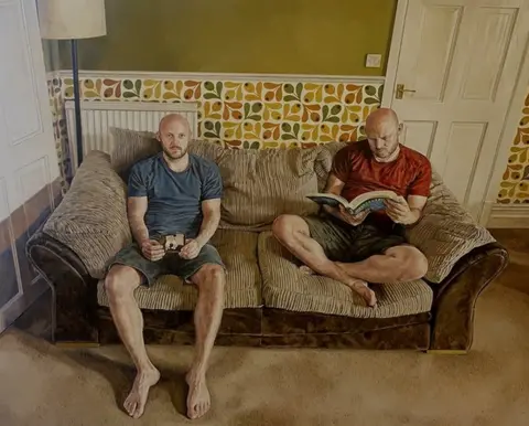 Michael Youds Twin brothers, Michael and David, sitting together on the couch