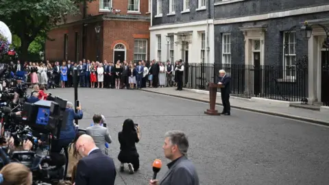Getty Images Boris Johnson, the press pack, his wife and supporters in Downing Street