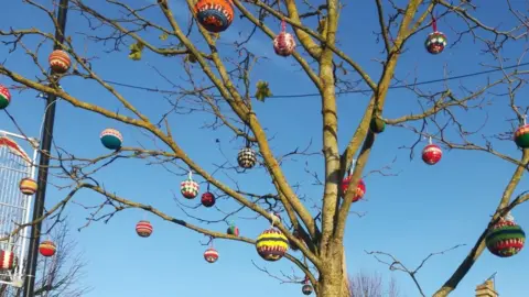 Higham Ferrers Town Council Knitted baubles in a tree