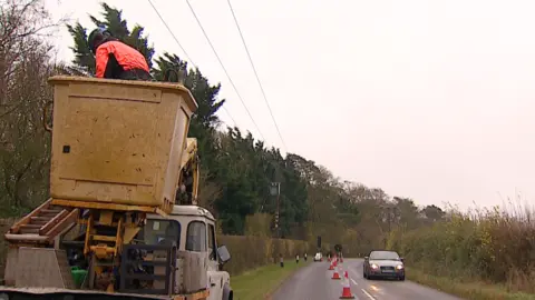 Robby West/BBC Road cones laid out to protect verge cutter