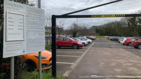 Martin Heath/BBC Car park showing sign in the foreground and cars in most of the spaces