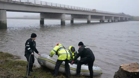 PA Media The police search and rescue team on the river bank near to Shard Bridge on the River Wyre