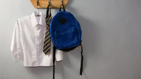 Getty Images A shirt, tie and bag hanging on hooks