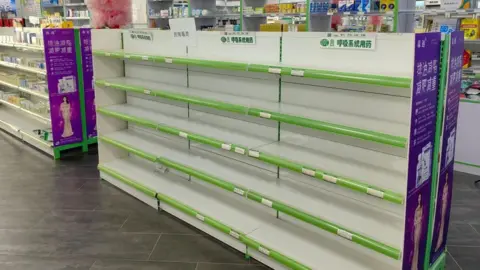Getty Images Empty medication shelves at a pharmacy in Xi'an