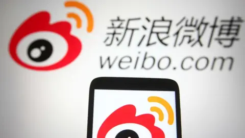 Getty Images Weibo (Sina Weibo) logo of a Chinese social media platform is seen on a smartphone and a pc screen.