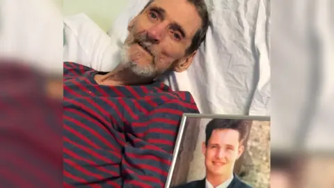 Harry Cichy/PA Terry Lubbock with a picture of his son, Stuart.