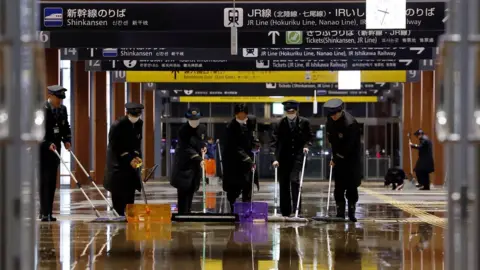 Reuters Railway workers try to remove water that leaked because of an earthquake at Kanazawa station in Kanazawa, Japan January 1, 2024, in this photo released by Kyodo.