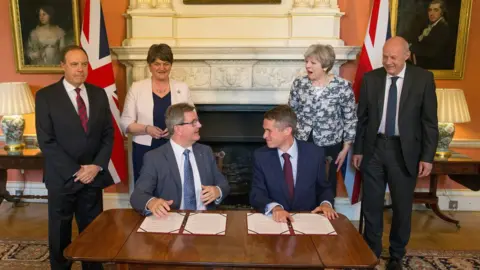 PA Media Jeffrey Donaldson pictured with then prime minister Theresa May after the DUP negotiated a confidence-and-supply deal with the Conservative Party in 2017