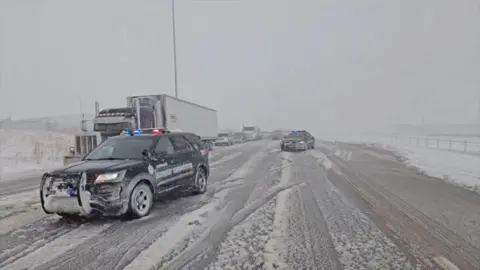 Cars are stuck on the highway after snowstorm.