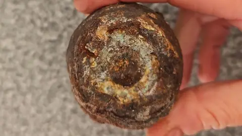 States of Jersey Police A rusted object being held in a person's hand.