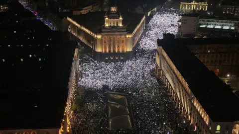 AFP via Getty Images Tens of thousands of protesters gather in central Sofia to demonstrate against the Buglarian government, in Sofia on December 10, 2025