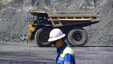 A worker stands in front of a lorry at an iron ore mine in Poltava, central Ukraine. File photo