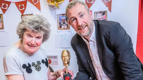 PA Media Taskmaster host Alex Horne with winner Christine Jesson at Seccombe Court care home in Adderbury.