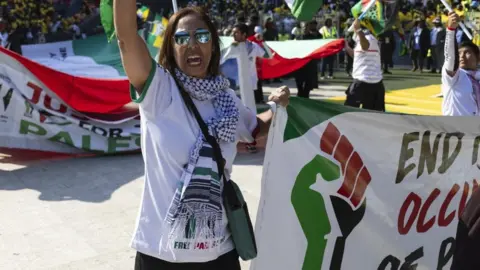 EPA Pro-Palestinian organizations carry Palestinian flags during the African National Congress Party (ANC) final election rally held at the FNB Stadium in Soweto, Johannesburg, South Africa, 25 May 2024