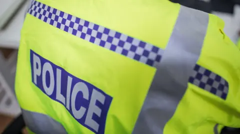 A stock image of a police officer's fluorescent jacket.