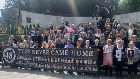 A number of the victims' families holding a banner at the Garden of Remembrance in Dublin city centre last year
