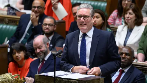 House of Commons Keir Starmer smiling in the hosue of Commons