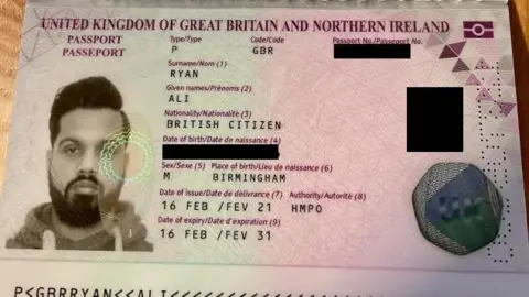 A police picture of the false UK passport that Aditya Rai obtained under the false name, Ryan Ali