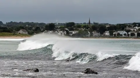 Anne Kelly A wave on Ballycastle beach. The sky is grey.