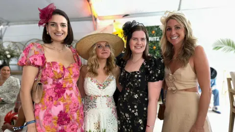 BBC/Brandon Drenon Four women posing for a photo inside the tent on the infield of Pimlico