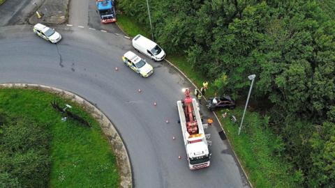 Drone shot of emergency services preparing the car for recovery