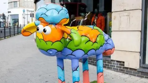 Alan Barnes A colourfully decorates statue of a sheep 