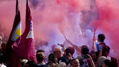 PA Media Smoke billows from flares as Villa fans gather in Birmingham.